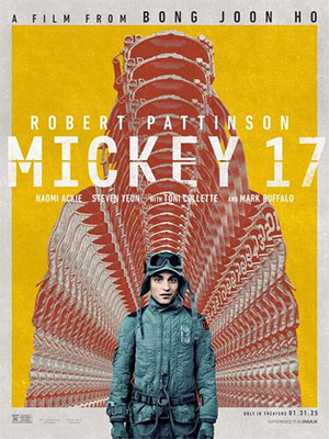 Poster do filme Mickey 17 onde o ator Robert Pattinson está em destaque usando uma roupa cinza, em fundo amarelo, Atrás dele, sua sombra na cor alaranjada aparece várias vezes, uma atrás da outra, e sobre elas consta seu nome e o título do filme.