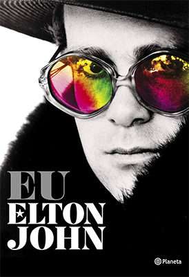 Capa do livro Eu, Elton John, onde o cantor aparece em close em fotografia preto e branco usando óculo redondos de lentes multicoloridas. Ele veste um casaco peludo, sobre o qual o título aparece em letras garrafais